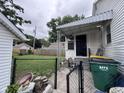 The home's fenced back porch area with a view of the backyard and neighboring houses at 1768 N Lynhurst Dr, Speedway, IN 46224