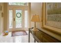 Welcoming foyer featuring a marble floor, decorative rug, console table, and a view of the glass-paned front door at 1870 Broadleaf Ct # 10, Greenwood, IN 46143