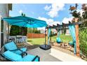 Outdoor living with cozy seating, a relaxing pergola, and a convenient grilling area for entertaining at 2020 Treving Dr, Cicero, IN 46034