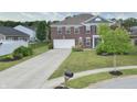 Charming brick two-story home with a long driveway, lush lawn, and plenty of curb appeal at 21491 Raccoon Ct, Noblesville, IN 46062