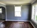 Inviting living room with hardwood floors and ample natural light from large windows at 2507 S Keystone Ave, Indianapolis, IN 46203