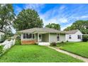 Charming single-story home with a well-manicured lawn and inviting curb appeal at 26 E Plum St, Anderson, IN 46012