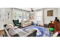 Open-concept living room with natural light, musical instruments and cozy furniture at 26 E Plum St, Anderson, IN 46012