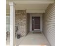 Inviting front porch with a stylish black door, brick accents, and space for outdoor seating at 2734 Newaygo Dr, Indianapolis, IN 46217