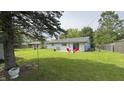 Expansive backyard featuring a patio, mature trees, and ample space for outdoor activities at 3019 E Berwyn St, Indianapolis, IN 46203
