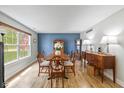 Traditional dining room featuring a wood table, buffet, and a blue accent wall illuminated by natural light at 317 Virginia St, Fortville, IN 46040