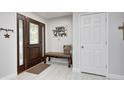Inviting entryway features a dark wood door, tiled floors, and a seating bench at 333 N Windswept Rd, Greenfield, IN 46140