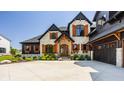 Beautiful home with stone and black accents, three-car garage and professionally landscaped yard at 3675 Dartmoor Way, Zionsville, IN 46077