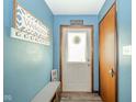 Inviting entryway with a 'Welcome' sign, coat hooks, and a convenient bench at 4210 Main St, Anderson, IN 46013