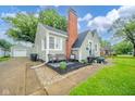 Home exterior featuring a cozy patio area with outdoor seating, and well maintained landscaping at 4210 Main St, Anderson, IN 46013