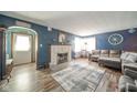 Cozy living room with a decorative fireplace, plush sofa, and stylish decor at 4210 Main St, Anderson, IN 46013