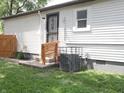 Cozy back entrance to home features an updated door, fresh exterior paint, and new steps at 4445 Kingsley Dr, Indianapolis, IN 46205
