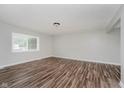 Bright living room with wood-look flooring, neutral paint, and ample natural light at 4514 Priscilla Ave, Indianapolis, IN 46226