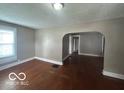 Inviting living room with hardwood floors and an open archway leading to other rooms at 521 N Alton Ave, Indianapolis, IN 46222