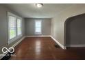 Inviting living room with hardwood floors and ample natural light from large windows at 521 N Alton Ave, Indianapolis, IN 46222