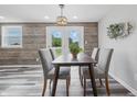 Inviting dining room with a table for four, modern lighting, and a view to the outside at 5503 Antoneli Ln, Indianapolis, IN 46237
