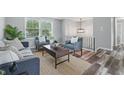 Cozy living room with modern furnishings, hardwood floors, and plenty of natural light at 5503 Antoneli Ln, Indianapolis, IN 46237