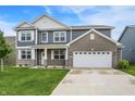 Attractive two-story home with gray siding, brick accents, manicured lawn, and a two-car garage, creating curb appeal at 5812 Flat Hill Dr, Indianapolis, IN 46239