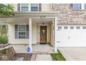 Charming front porch with a decorative wooden door, sidelights, and a welcoming entrance at 6259 Teacup Dr, Indianapolis, IN 46235