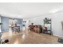 Spacious living room featuring wood floors, modern lighting, and open access to the kitchen at 6259 Teacup Dr, Indianapolis, IN 46235