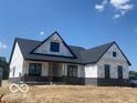 New home featuring black brick, a dark shingled roof, and dark trim at 6638 Dogwood Dr, McCordsville, IN 46055