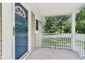 Charming front porch with a white railing offers a clear view of the street and a welcoming entrance at 7141 E Pleasant Run Pkwy S Dr, Indianapolis, IN 46219