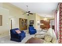 Cozy living room featuring neutral walls and carpet, stylish seating, and seamless flow to the dining area at 786 Woodview North Dr, Carmel, IN 46032