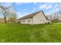 View of the house from the spacious backyard showing the vinyl siding and well-maintained lawn at 8038 Midlothian Way, Indianapolis, IN 46214