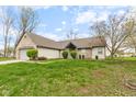 Lovely single-story home featuring brick and vinyl siding, a well-manicured lawn, and mature landscaping at 8038 Midlothian Way, Indianapolis, IN 46214
