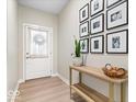 Inviting entryway with light wood floors, console table, and decor creating a welcoming ambiance at 8547 Winton Pl, Pendleton, IN 46064