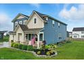 A charming two-story home with lush landscaping and a covered front porch create an inviting curb appeal at 8547 Winton Pl, Pendleton, IN 46064