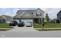 Inviting home with a well-manicured lawn, wide driveway, and a two-car garage at 9068 Thames Dr, Avon, IN 46123
