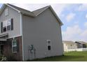 Side view of a home showcasing vinyl siding and several windows for natural light at 9068 Thames Dr, Avon, IN 46123