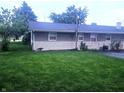 Exterior view of the rear of the home and a large backyard with lawn at 9470 N Old Port Royal, Martinsville, IN 46151