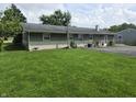 Expansive backyard with lush green lawn, complemented by a brick and siding exterior with mature plants at 9470 N Old Port Royal, Martinsville, IN 46151