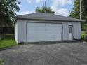 Detached two car garage featuring a large access door and side door, situated on a paved driveway at 9470 N Old Port Royal, Martinsville, IN 46151