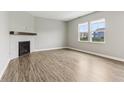 The airy living room showcases a fireplace, hardwood floors, and natural light at 9498 Tobin Cir, Avon, IN 46123