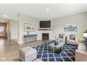 Bright living room with a fireplace, hardwood floors, and stylish decor at 9498 Tobin Cir, Avon, IN 46123
