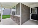 A covered porch with brick accents, providing a cozy and inviting entrance to the home at 9498 Tobin Cir, Avon, IN 46123