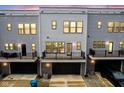 Townhome exterior features private balconies, a black garage door, and a clean, modern design at 9728 Junction, Fishers, IN 46037