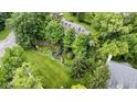 Beautiful aerial view of a well-manicured property featuring a lush green lawn and mature trees at 9985 Ford Valley Ln, Zionsville, IN 46077