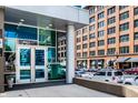 Modern building entrance with glass doors and a view of street parking at 1 Virginia Ave # 607, Indianapolis, IN 46204