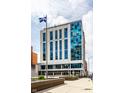 Modern commercial building with blue glass accents and a flag at 1 Virginia Ave # 607, Indianapolis, IN 46204