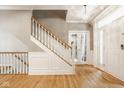 Welcoming foyer with hardwood floors, staircase, wainscoting, and ample natural light highlighting the elegant interior at 12505 Branford St, Carmel, IN 46032