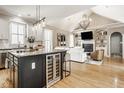 Open-concept living space featuring a kitchen island, vaulted ceilings, fireplace and hardwood floors providing a modern feel at 12505 Branford St, Carmel, IN 46032