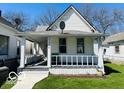 Charming house featuring a covered front porch and a well-maintained lawn at 1358 Hiatt St, Indianapolis, IN 46221