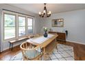 Bright dining room with a wooden table, modern chandelier, and large windows at 1415 Section St, Plainfield, IN 46168
