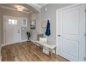Inviting foyer features hardwood floors, a bench, and coat rack for an organized entrance at 14892 Higgins Dr, Westfield, IN 46074
