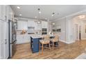 Stylish kitchen boasts a central island with seating, stainless steel appliances, and ample cabinetry at 14892 Higgins Dr, Westfield, IN 46074
