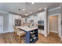 Stylish kitchen boasts a central island with seating, stainless steel appliances, and ample cabinetry at 14892 Higgins Dr, Westfield, IN 46074